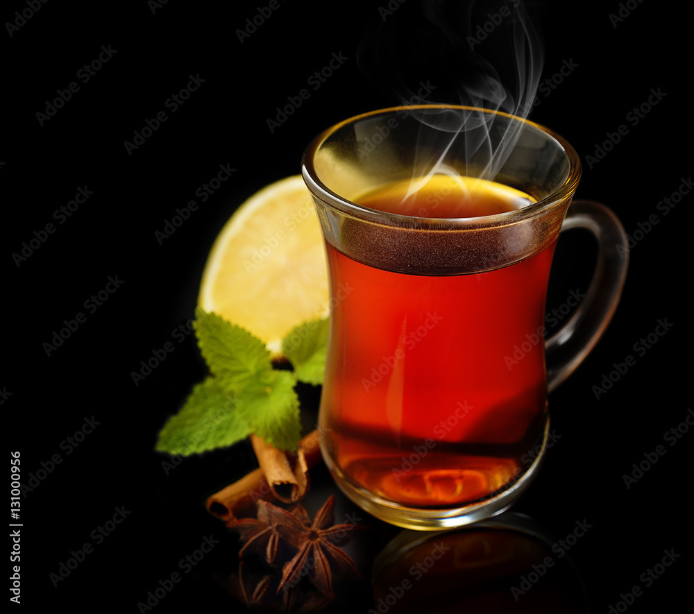 tea, lemon, cinnamon and mint on a black background tea, lemon, cinnamon and mint on a black background