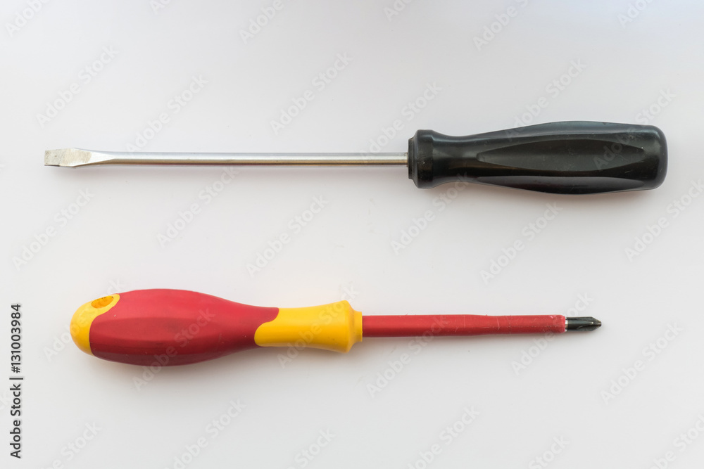 Small screwdriver and phillips screwdriver / Small screwdriver and phillips screwdriver on white background,close-up Small screwdriver and phillips screwdriver / Small screwdriver and phillips screwdriver on white background,close-up