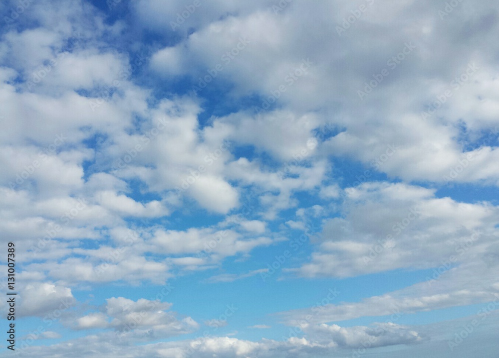 Beautiful fluffy clouds in blue sky, natural background 