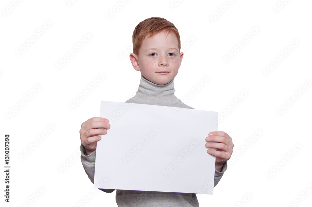 Smiling boy holding a white sheet of paper, on a white backgroun Smiling boy holding a white sheet of paper, on a white backgroun