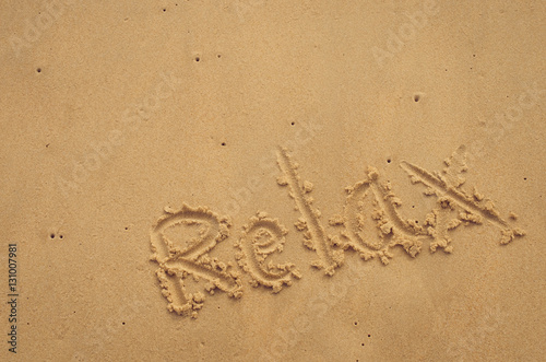 Copy space of Relax words on sand beach texture background.