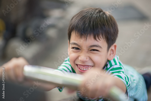 Close up of Little cute  boy playing slider at playground