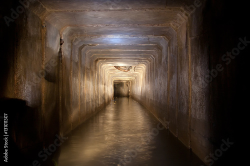 Flooded sewer tunnel with dirty polluted water of underground river under Vorone