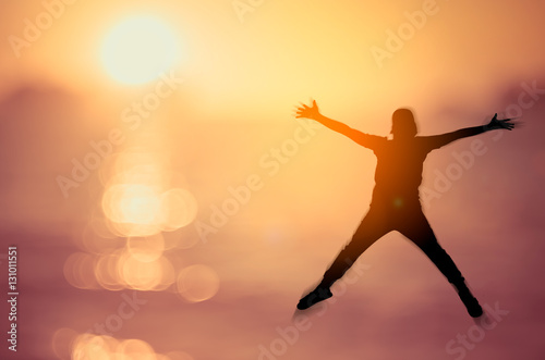 Feel good and freedom concept. Copy space of happy man jumping on tropical sunset beach.