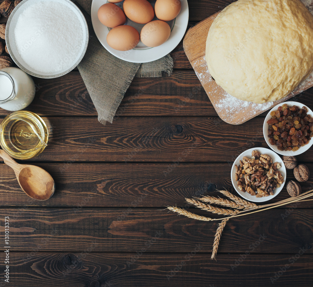 Top view Baking ingredients for homemade pastry on dark rustic wood background Top view Baking ingredients for homemade pastry on dark rustic wood background