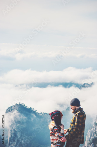 Couple Man and Woman hugging enjoying together and mountains with clouds landscape on background Love and Travel happy emotions Lifestyle concept. Young family traveling active adventure vacations