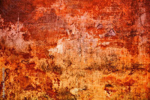 Vintage mottled frame  textured grunge background. Abstract old surface closeup of red and orange. Art design process. Colorful scratched background