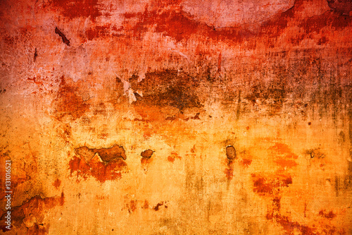 Abstract background bright saturated red and yellow colors. Old rough surface