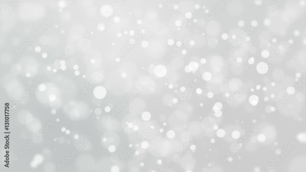 Beautiful soft silver white background with moving light particles creating a bokeh effect. Beautiful soft silver white background with moving light particles creating a bokeh effect.