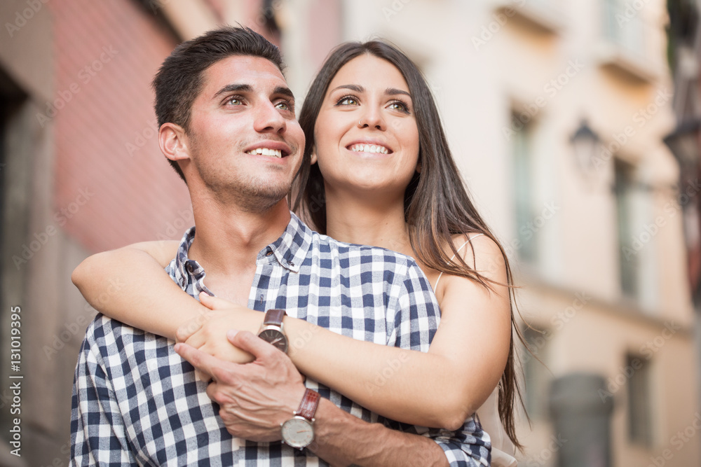 Fototapeta premium Portrait of smiling young and beautiful couple hugging