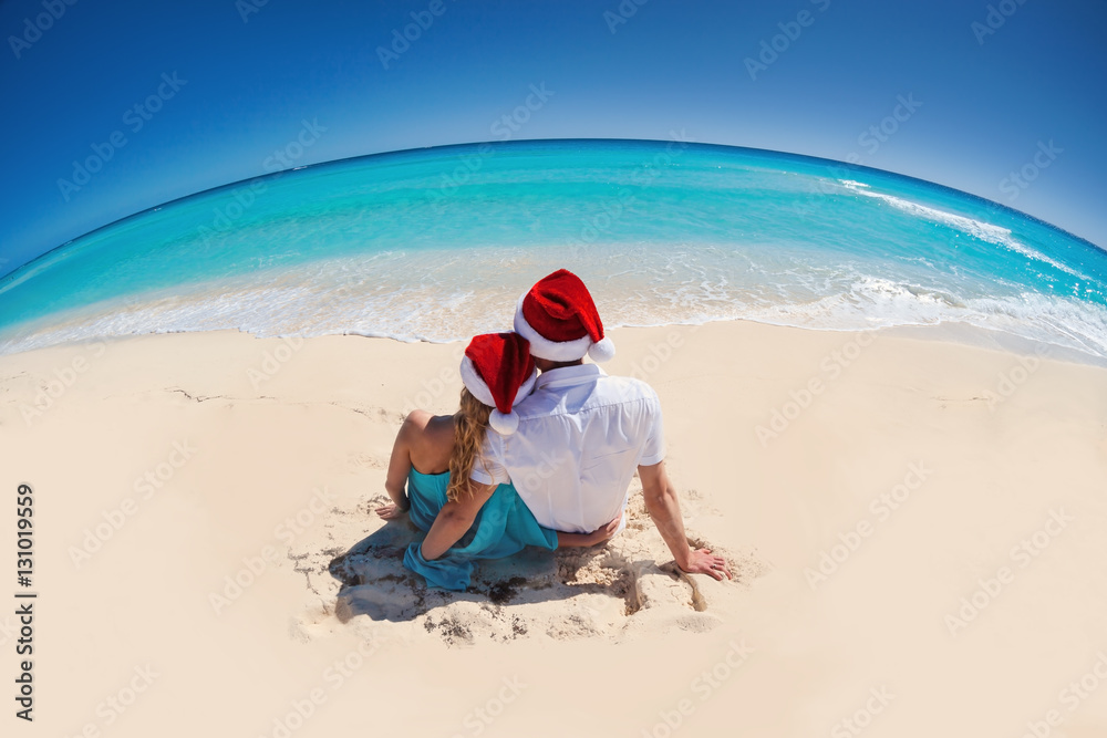 Christmas Greeting card with couple in Santa Hats Christmas Greeting card with couple in Santa Hats