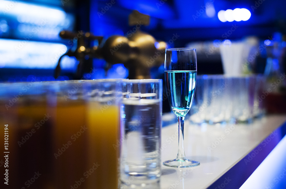 Glass with Blue Champagne, Glass with Juice in the Foreground Glass with Blue Champagne, Glass with Juice in the Foreground