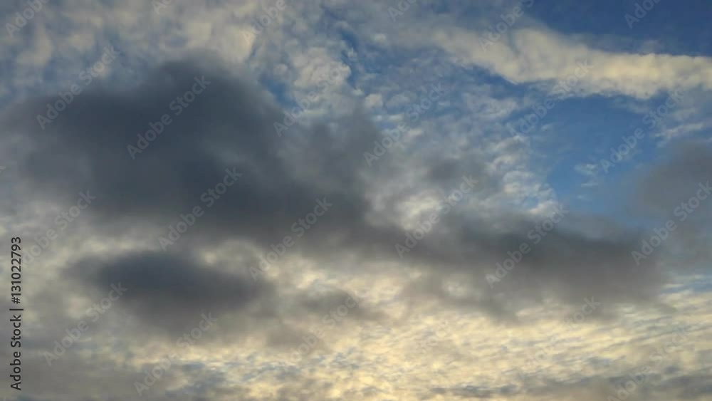 Colorful clouds at different heights fast flying through the blue evening sky. Timelapse Colorful clouds at different heights fast flying through the blue evening sky. Timelapse