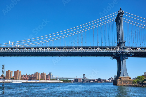 Manhattan Bridge crossing East River with Williamsburg Bridge in the background in New York City
