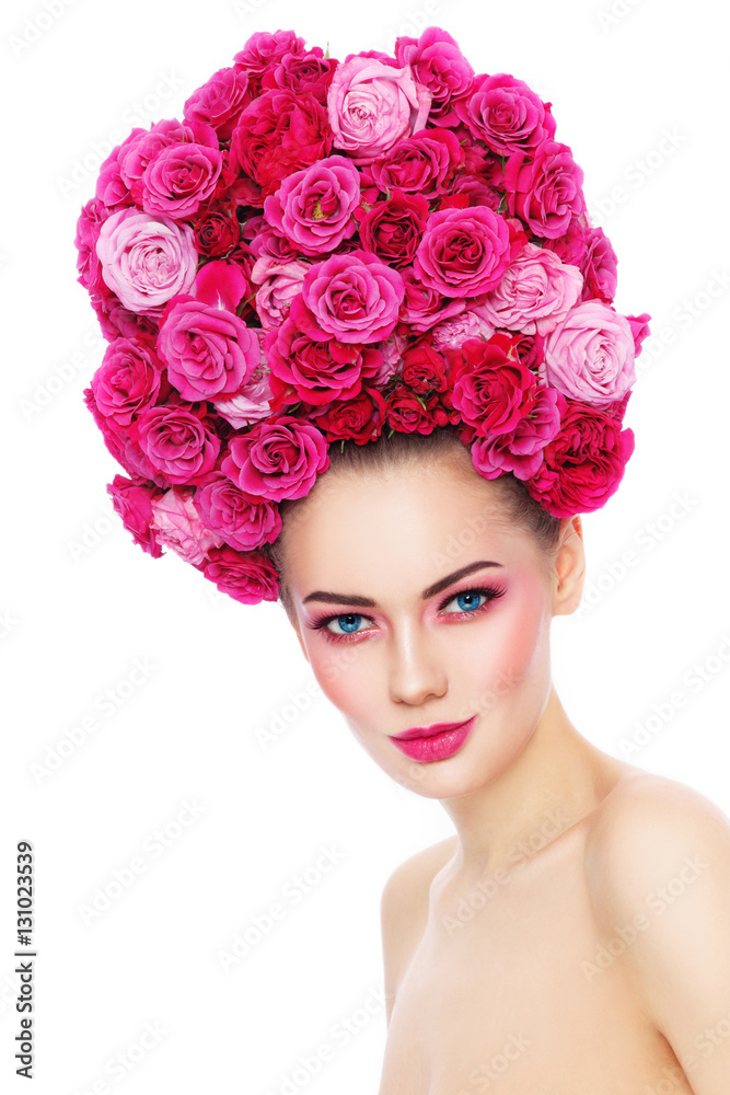Young beautiful woman with stylish make-up in fancy vintage style wig of pink roses over white background