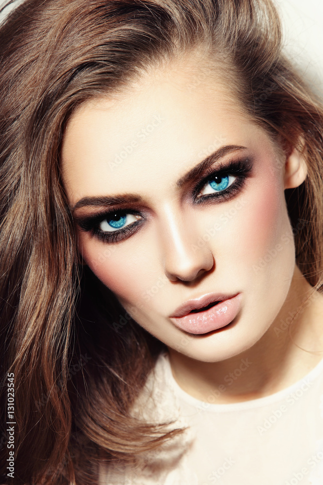 Portrait of young beautiful blue-eyed woman with smoky eyes Portrait of young beautiful blue-eyed woman with smoky eyes