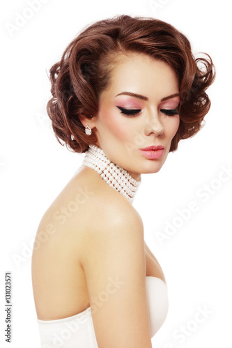 Young beautiful sexy woman with winged eyes make-up and curly hairstyle over white background