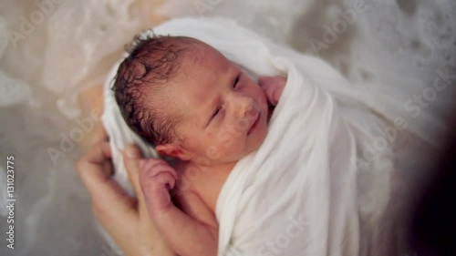 Newborn baby relaxing in bathtube photo