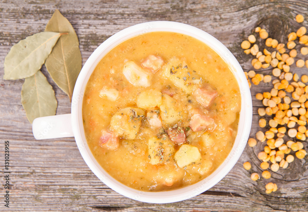 Split pea soup, decorated with some bay leaves, marjoram and peas Split pea soup, decorated with some bay leaves, marjoram and peas