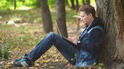 Man Using Laptop in The Park 