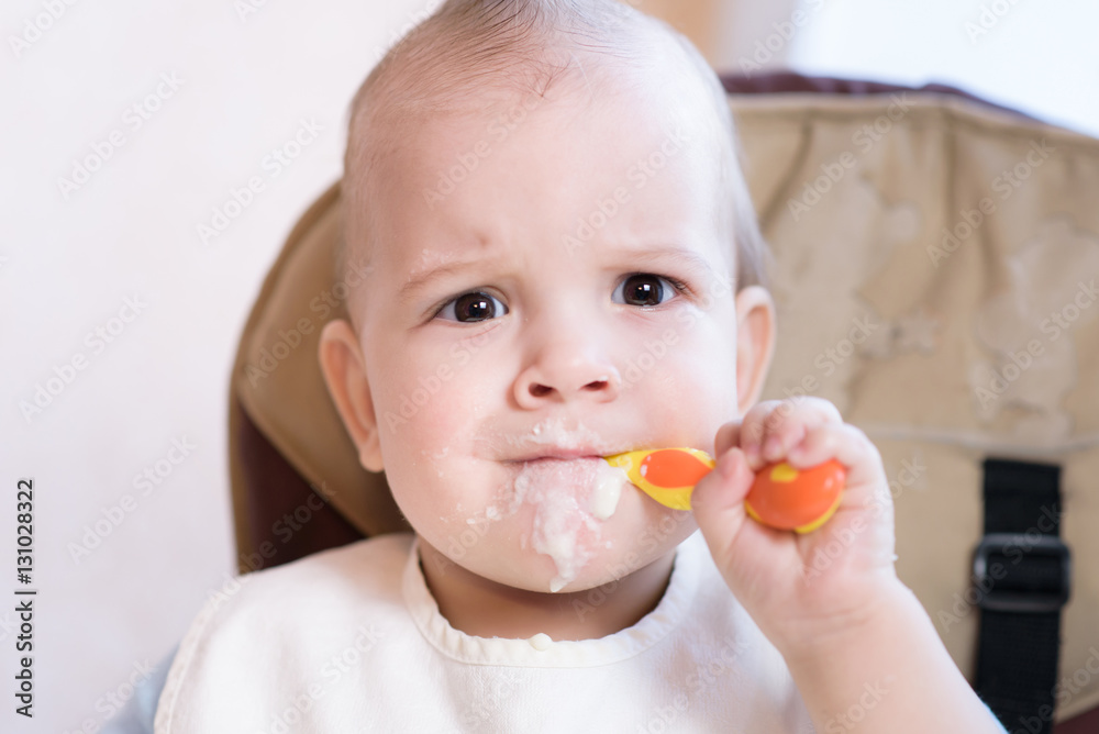 baby holding a spoon in his mouth baby holding a spoon in his mouth