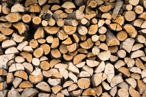 wall firewood , Background of dry chopped firewood logs in a pil