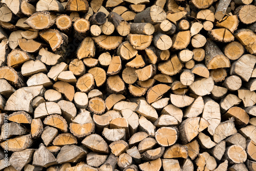 wall firewood , Background of dry chopped firewood logs in a pil