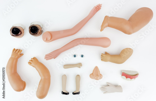 Doll body parts on a white background. Fototapet