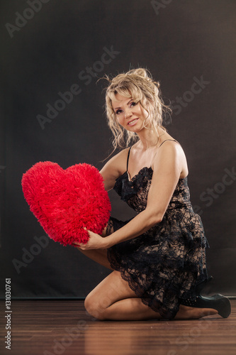 Mature woman hug big red heart