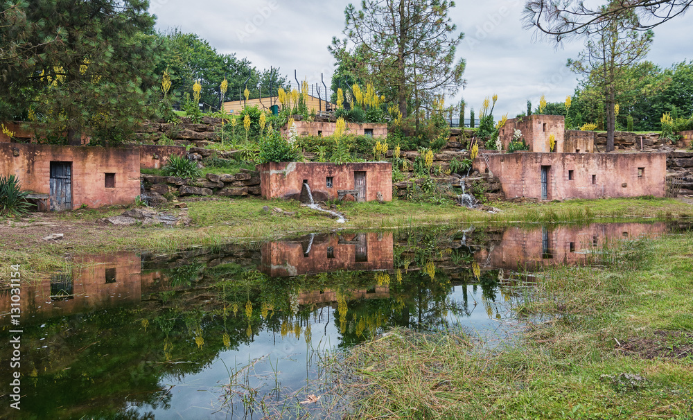 Fototapeta premium Terracotta houses with reflection in a pond