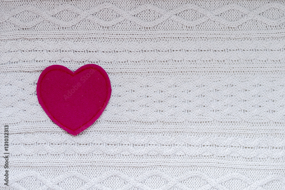 Red heart on white knitted background Red heart on white knitted background