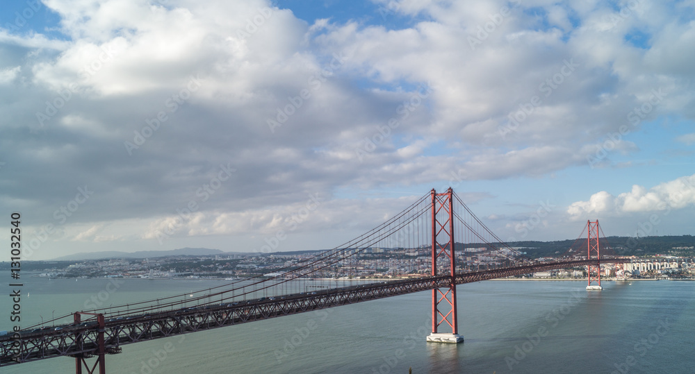 Obraz premium A view of the Tagus river and bridge on 25 October in Lisbon, Portugal