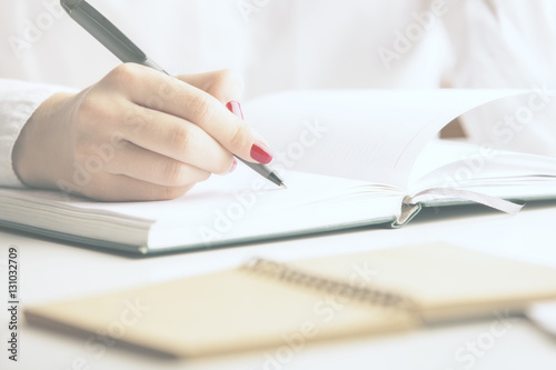Girl writing in notepad © peshkova