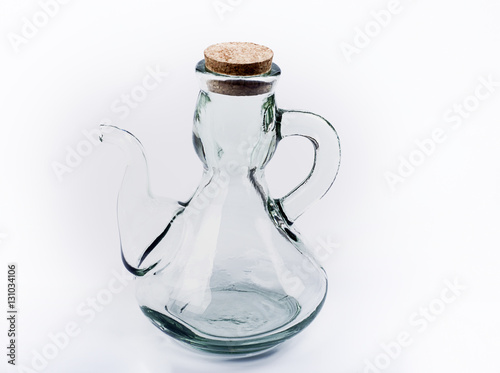 Glass oil bottle with cork stopper on white background. Isolated.