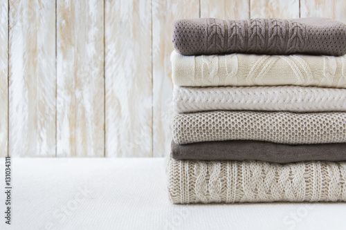 Stack of warm cozy light sweaters