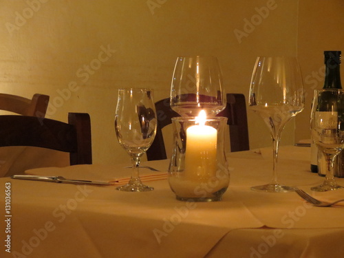 Candle and glasses on a restaurant tablle photo