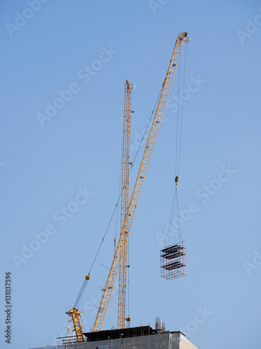 Industrial construction crane on high building