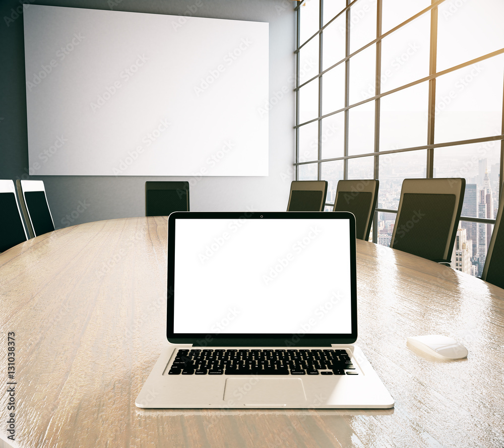 Blank white laptop on conference table Blank white laptop on conference table