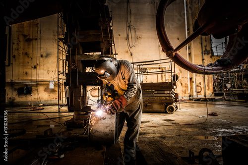 Man welding at a shipyard