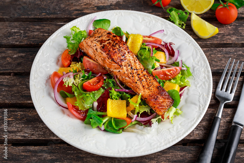 Fried Salmon steak with fresh vegetables salad. concept healthy food.