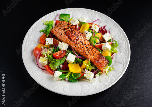 Fried Salmon steak with fresh vegetables salad. concept healthy food.