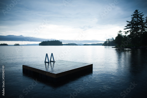 Floating dock on a lake in a rain shower