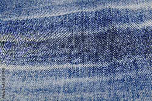 Texture of blue jeans fabric with white stripes.