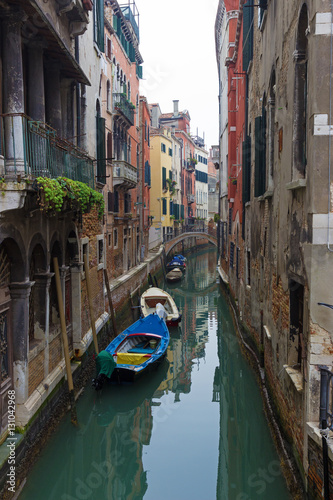 Typical Venice canal with moored boats and colorful buildings