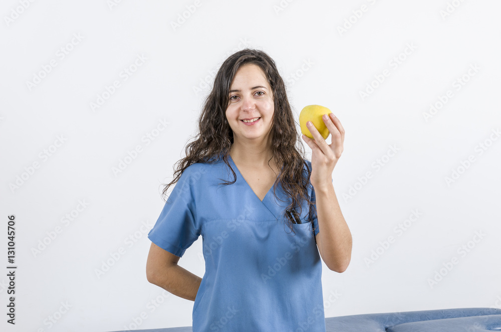 Happy doctor holding an apple in her hand. Happy doctor holding an apple in her hand.