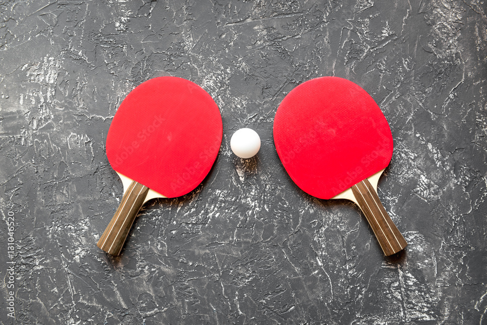 Red racket for ping pong ball gray background top view Red racket for ping pong ball gray background top view