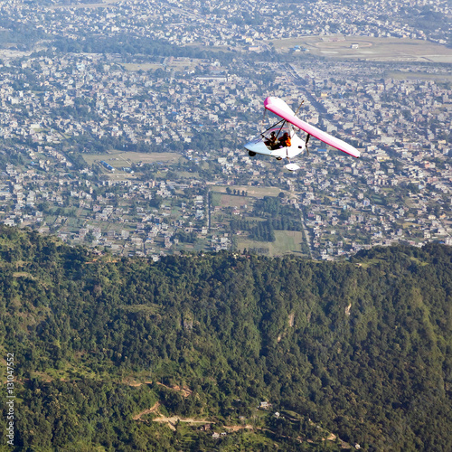 Motor hang-gliding in flight over the city of Pokhara - Nepal, Himalaya photo