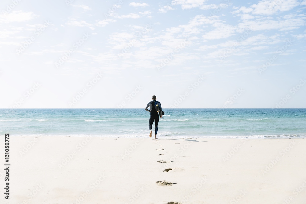 Handsome man kitesurfer running. Handsome man kitesurfer running.