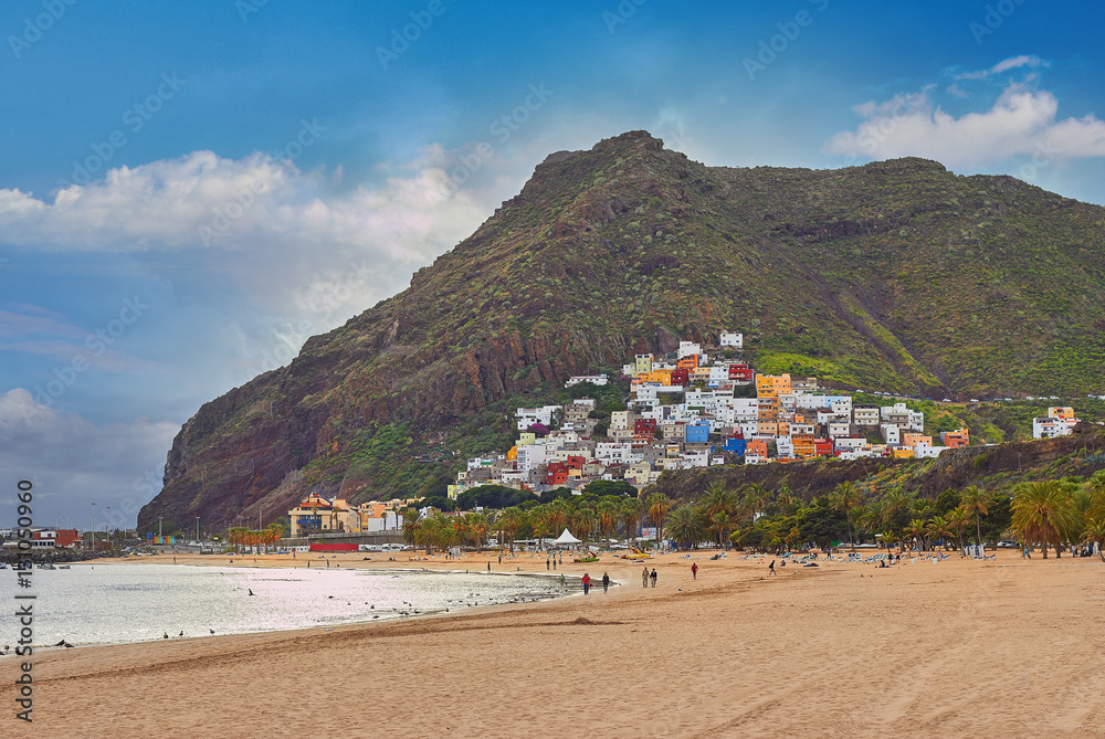 Amazing view of beach las Teresitas with yellow sand, umbrellas,