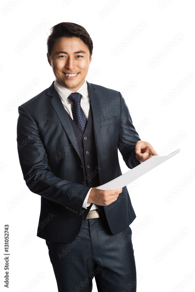 Handsome businessman in a blue suit, vest and tie, standing against a white background holding a blank paper gesturing, looking at camera with a big smile. Handsome businessman in a blue suit, vest and tie, standing against a white background holding a blank paper gesturing, looking at camera with a big smile.
